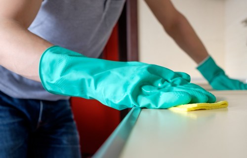 Upholstery cleaner treating a fabric sofa in an Edgware home